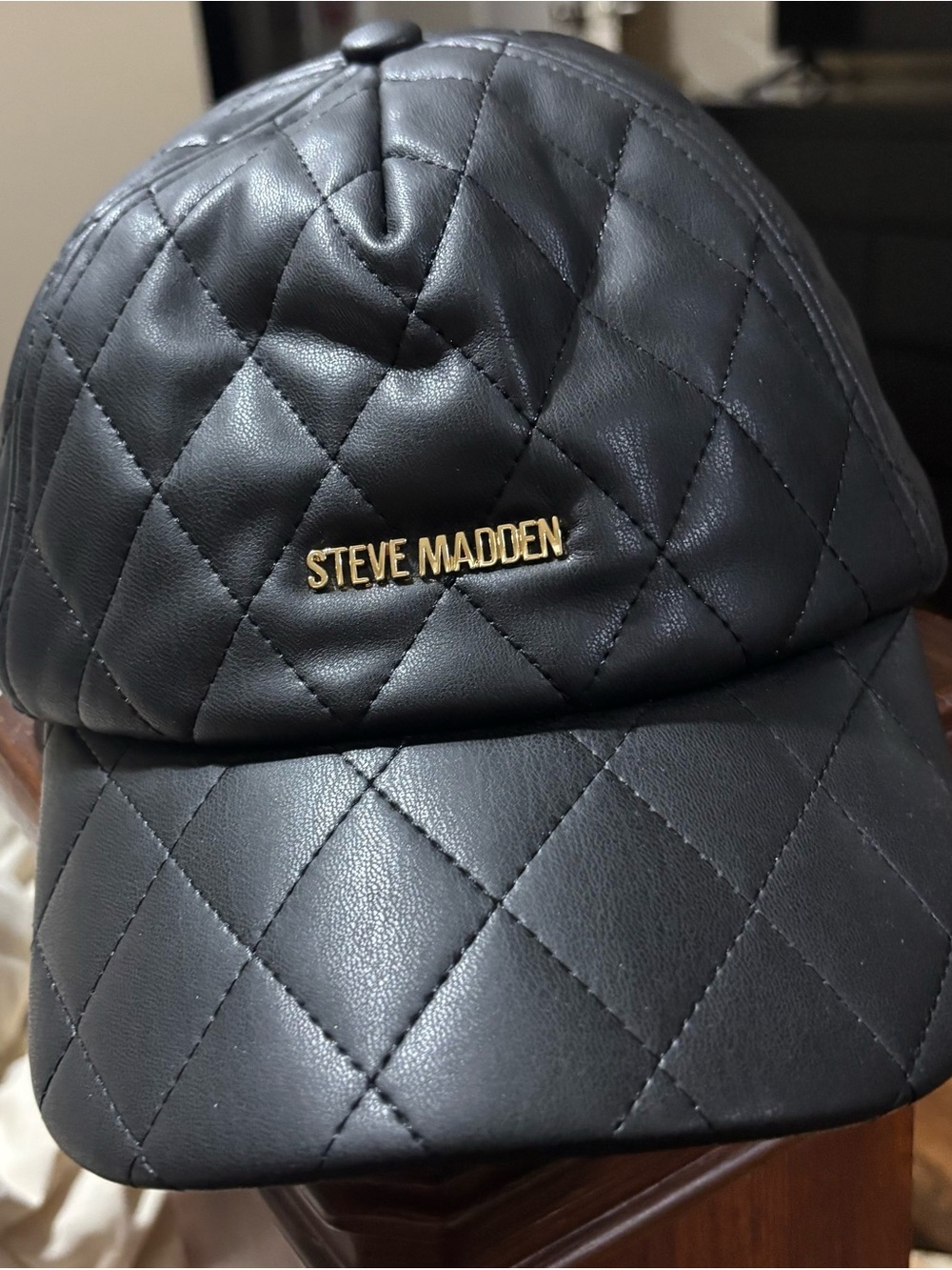 Steve Madden Quilted Black Leather-Look Cap with Gold Logo